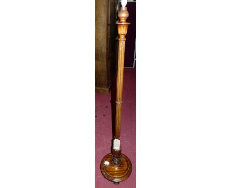 A mahogany standard lamp having a reeded column with shadeCondition report: Lamp is wired but untested. Condition is good wit
