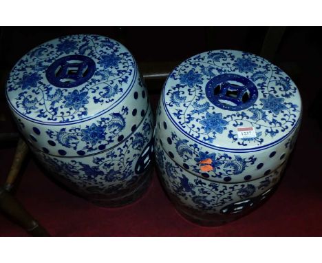 A pair of Chinese style glazed and blue and white decorated ceramic garden barrel seats, each h.44cm