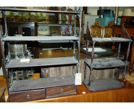 A 19th century mahogany four-tier hanging wall shelf, having twin lower drawers (damaged to one side of upper decoration), w.