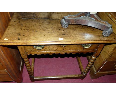 An 18th century joined oak single drawer side table, raised on bobbin turned supports, united by lower stretchers, width 92cm