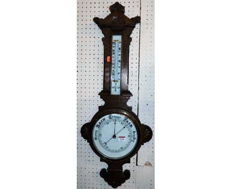 An early 20th century carved oak two-dial aneroid barometer, height 82cm