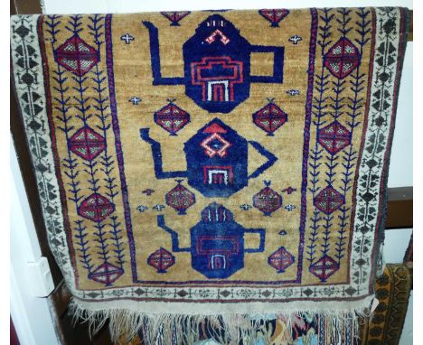 An unusual Persian rust ground woollen prayer rug, with central repeating teapot design, 120 x 79cm, together with two small 