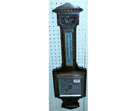 An early 20th century relief carved oak aneroid two-dial barometer, height 49cm