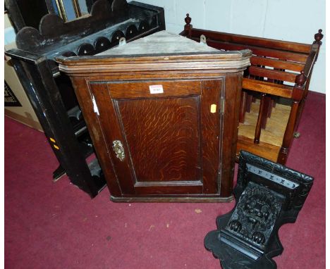 An antique joined oak small hanging corner cupboard; together with a carved and ebonised oak wall bracket; a made-up antique 