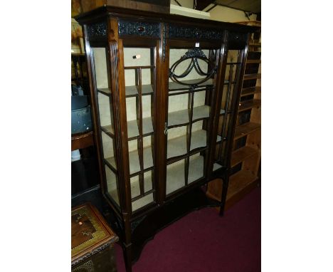 A circa 1900 mahogany 'Chippendale' single door glazed display cabinet, having floral relief carved decoration, fixed interio