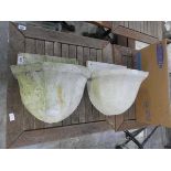 Pair of weathered concrete wall mounted planters