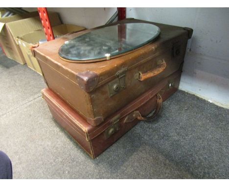 Two vintage suitcases and a bevel edged mirror 