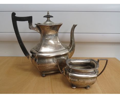 A Walker and Hall silver teapot and twin handle sucrier, gadrooned rims, stirrup form handles, squashed bun feet, Sheffield 1