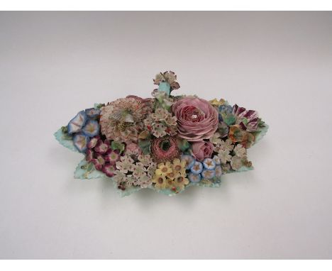 An elaborate and flower encrusted Meissen double inkwell with insect to lid, crossed sword marks to base 