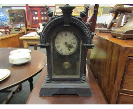 A UCC mantel clock with pendulum and key.  51cm height 
