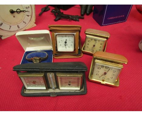 A travel clock, barometer and thermostat with four other travel clocks 