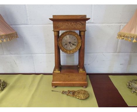 An inlaid four pillar mantel clock with pendulum 