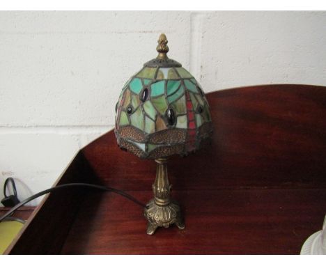 A Tiffany style bronzed table lamp with leaded glass dragonfly shade, 32cm tall 