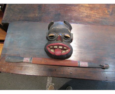 An African carved wooden mask and a tribal stick 