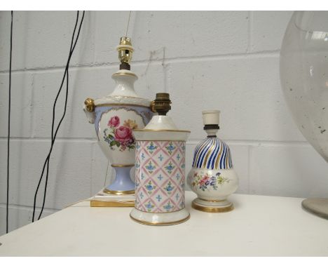 An Alka lamp, a Limoges lamp and one other with crossed sword mark to base (3) 