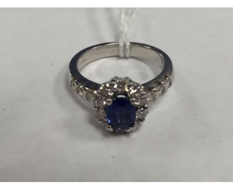 An 18ct white gold diamond and sapphire cluster ring set in platinum.