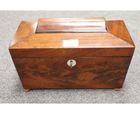A Victorian mahogany tea caddy, width 30 cm. CONDITION REPORT: On later wooden feet, with a glass liner which is later, mostl
