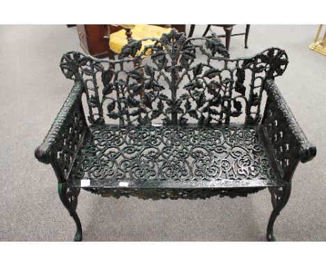 A Victorian style cast iron garden bench, width 104cm