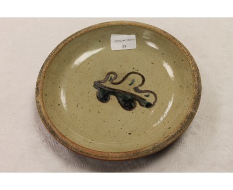 A Leach Pottery St. Ives stoneware dish decorated with an oak leaf, width 21 cm. CONDITION REPORT: Good condition, impressed 