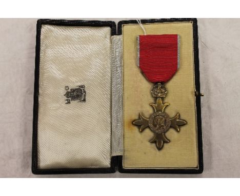 An O.B.E medal awarded to Charles R. Flynn, cased with award letter. CONDITION REPORT: Good condition.
