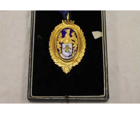 A 9ct gold and enamel Gentleman's medallion on blue ribbon, 41g, boxed. CONDITION REPORT: Excellent condition, enscribed to t