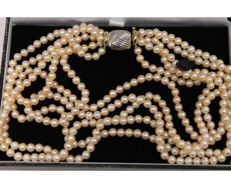 A five-strand pearl necklace with two-tone gold clasp, length 44 cm. CONDITION REPORT: Good condition.