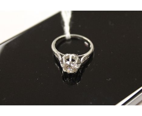 A platinum solitaire diamond ring, with diamond shoulders. CONDITION REPORT: Good condition.