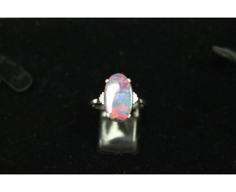 An 18ct white gold Art Deco style opal ring. CONDITION REPORT: Very small nibble to the edge of the opal, otherwise good.