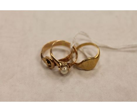 A 14ct gold pearl ring, together with an 18ct gold signet ring and a yellow metal buckle ring. (3) CONDITION REPORT: 18ct rin