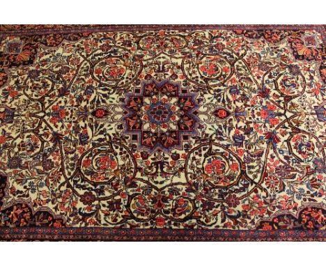 An Iranian wool carpet, on cream ground, 224 cm x 148 cm.