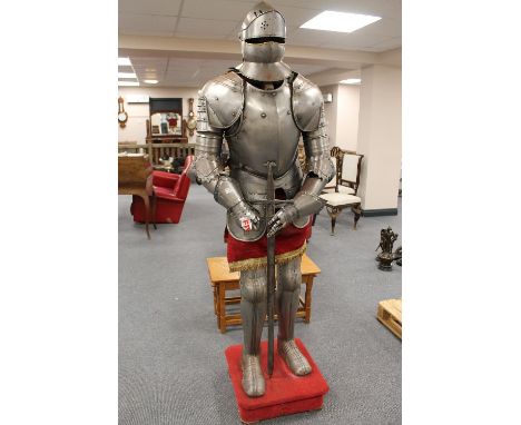 A suit of armour together with broad sword and helmet. CONDITION REPORT: Good condition, date unknown.