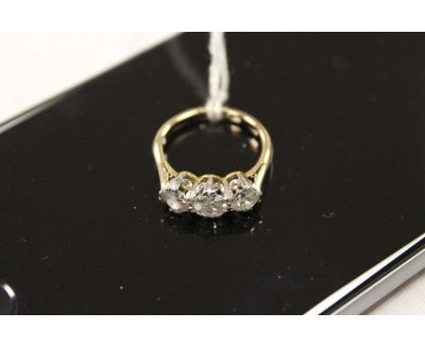 A three stone diamond ring, approximately 1.5ct. CONDITION REPORT: Yellow metal tested as 18ct. Good condition.