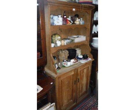 A 19TH CENTURY CONTINENTAL STRIPPED PINE DRESSER of small proportions with panel doors below