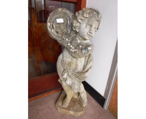 A RECONSTITUTED STONE GARDEN STATUE OF A CHERUB playing a tambourine