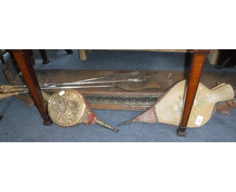 A SET OF THREE VICTORIAN POLISHED STEEL FIREPLACE TOOLS with brass handles, a similar fender and two bellows