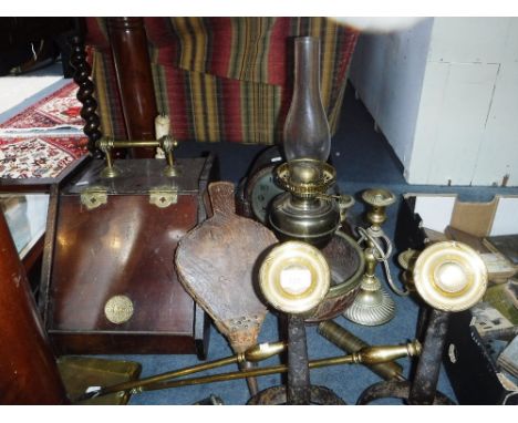 A PAIR OF IRON FIRE DOGS, a plated candlestick, oil lamps, a mantel clock and similar items (as lotted)