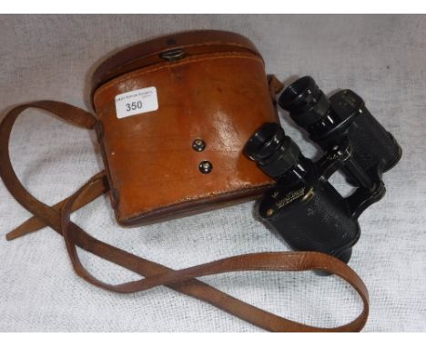 BAUSCH & LOMB OPTICAL COMPANY ROCHESTER N.Y: A PAIR OF BINOCULARS in a fitted leather case, the lid with a fitted compass