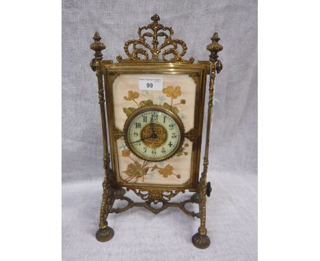 A VICTORIAN BRASS AESTHETIC PERIOD MANTEL CLOCK, the movement mounted within a ceramic plaque, painted with leaves and flower