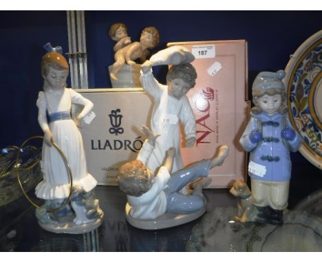 A COLLECTION OF LLADRO AND NAO FIGURES to include a girl with a hoop and puppy 