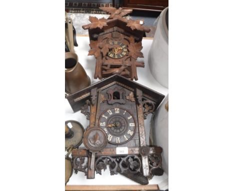 A 19TH CENTURY BLACK FOREST CUCKOO CLOCK and another similar