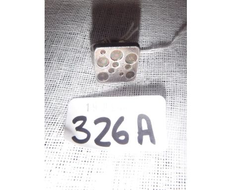 A GEORGE JENSEN SILVER ABSTRACT RING, the square shaped plaque with rounded corners decorated with bubble motifs, signed Geor