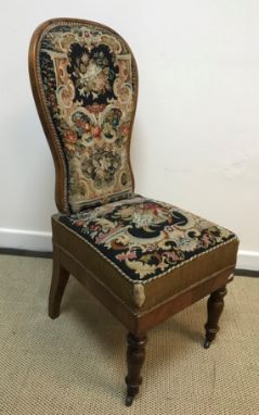 A Victorian walnut framed spoon back prie a dieu type chair, the back and seat with needlework scrolling floral and foliate d
