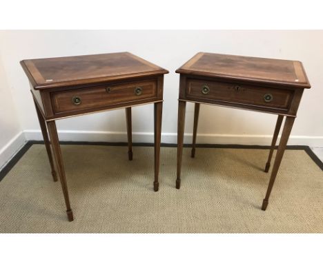 A pair of mahogany and inlaid lamp tables in the Regency taste, the cross-banded tops with moulded edge over a single frieze 
