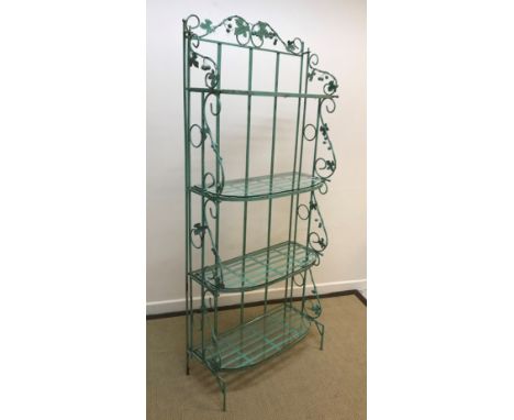 A modern green painted wrought iron shelf unit with grape and vine decoration, the folding sides supporting four graduated sh