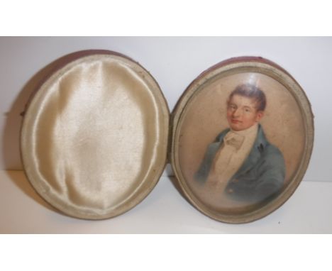 H HARDING "Young gentleman in blue overcoat with white stock and waistcoat", a portrait study, watercolour, oval, signed and 