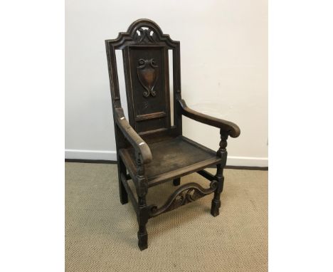 A 19th Century walnut framed hall chair in the Carolean taste, the shell and scroll work carved back above an upholstered sea