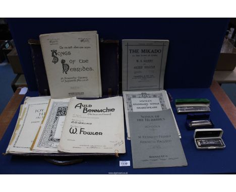 A leather case containing music books including; 'The Mikado', 'Songs of the Hebrides', etc. Plus three harmonicas; two being