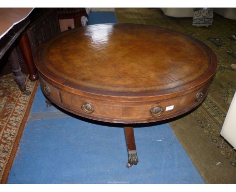 A nice quality low Mahogany Drum Table having an inset brown leather top with gold tooling, four frieze drawers to the rotati