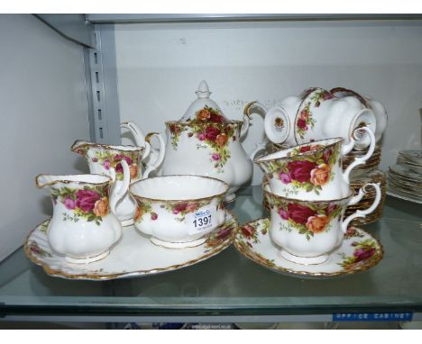 A Royal Albert 'Old Country Roses' tea service including; teapot, six cups and saucers, eleven tea plates, sandwich plate, su