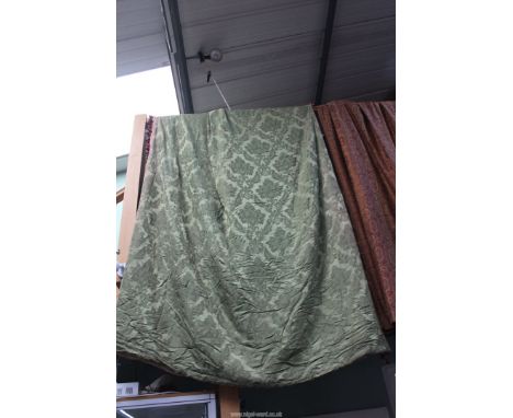 A large pair of green brocade interlined curtains having red and green tassel edging (some staining) both 66" wide x 112" dro